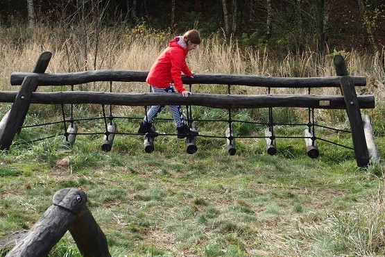 Person går balancegang i naturen.